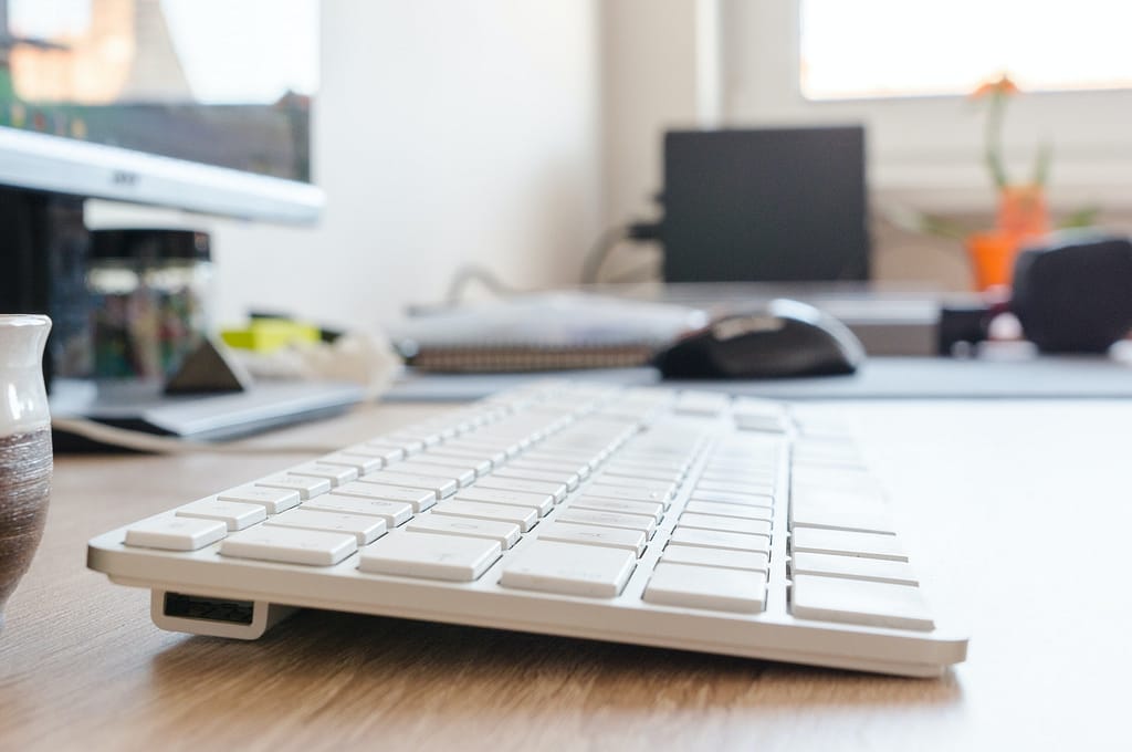 A computer keyboard on a desk