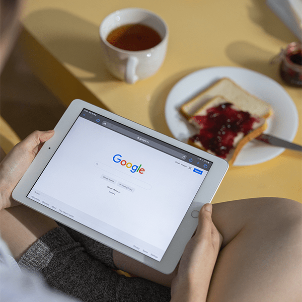 An image of a women using Google on their iPad.
