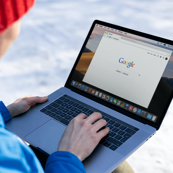 An image of someone using Google on their MacBook.